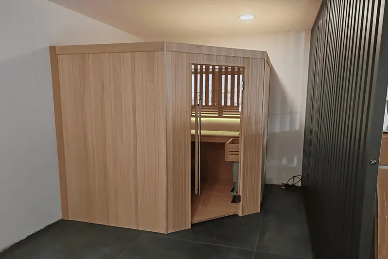 Sauna finlandais d'angle Alpha Wellness en bois d'ayous monté dans une pièce à Thézan-lès-Béziers