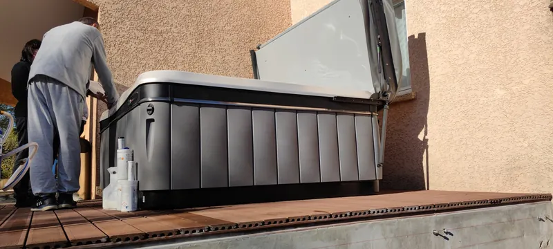 Spa en cours de remplissage, un technicien visible de dos